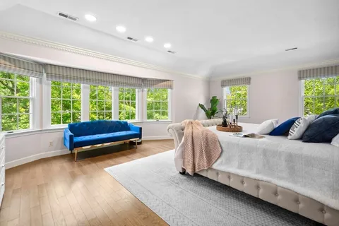 a bedroom with a bed and a couch