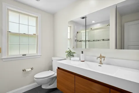 a bathroom with a sink toilet and shower