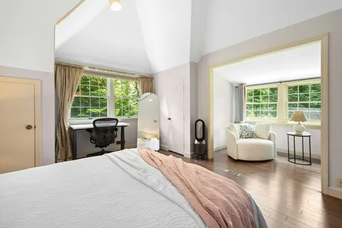 a bedroom with a bed and a large window