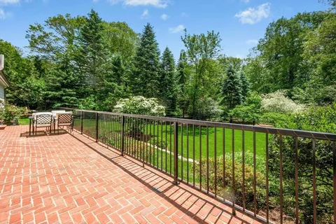 a view of balcony with deck and trees