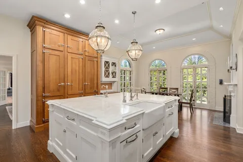 a large white kitchen with a large window