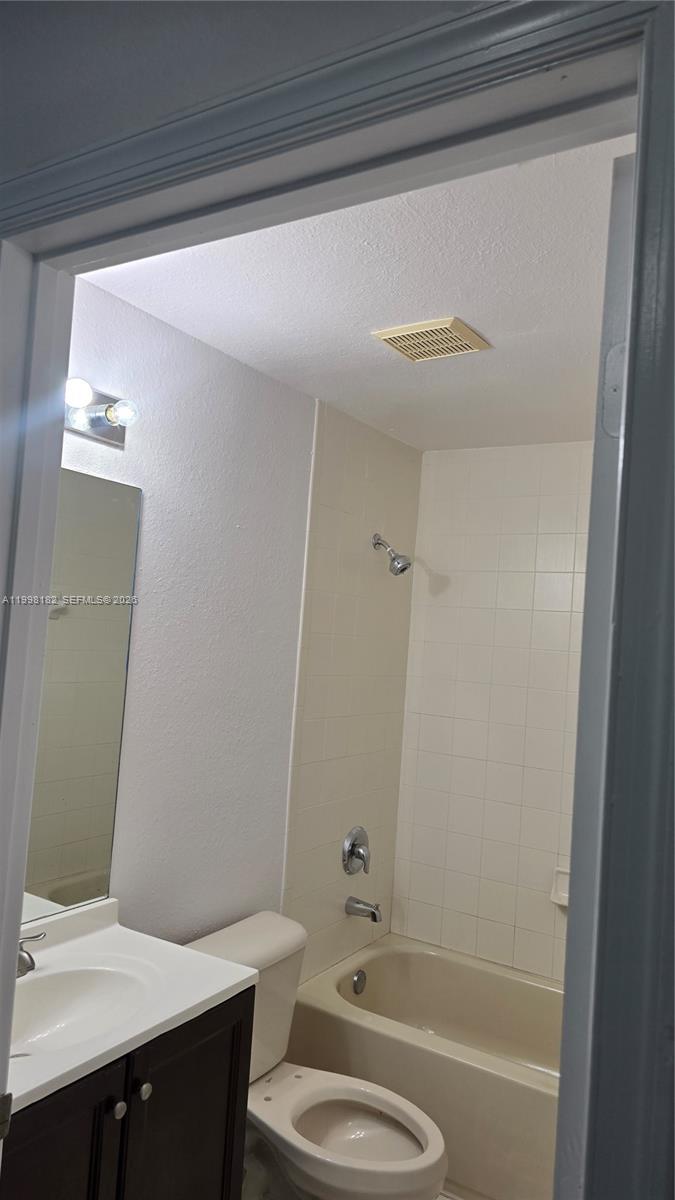 2755 Southeast 15th Road, Unit 101 Homestead, FL 33035 - Photo 17 of 18 a bathroom with a sink a toilet and shower