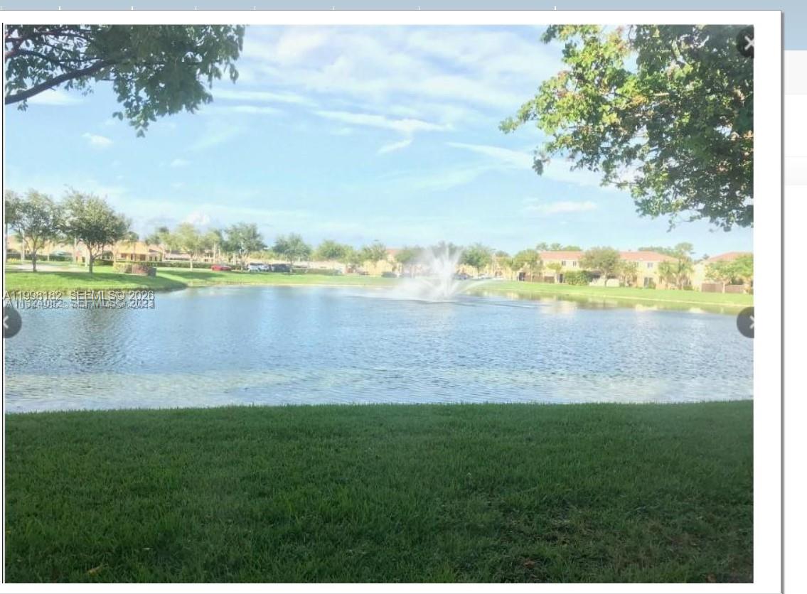 2755 Southeast 15th Road, Unit 101 Homestead, FL 33035 - Photo 2 of 18 a view of a lake with a big yard