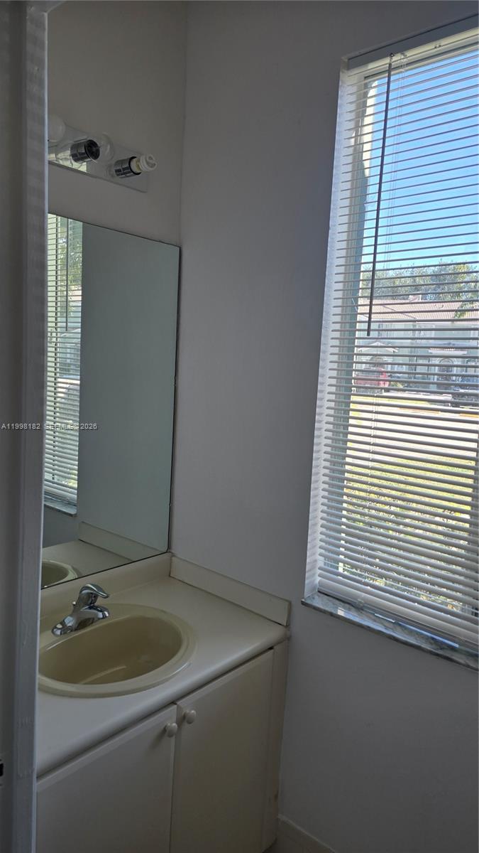 2755 Southeast 15th Road, Unit 101 Homestead, FL 33035 - Photo 7 of 18 a bathroom with a sink and window