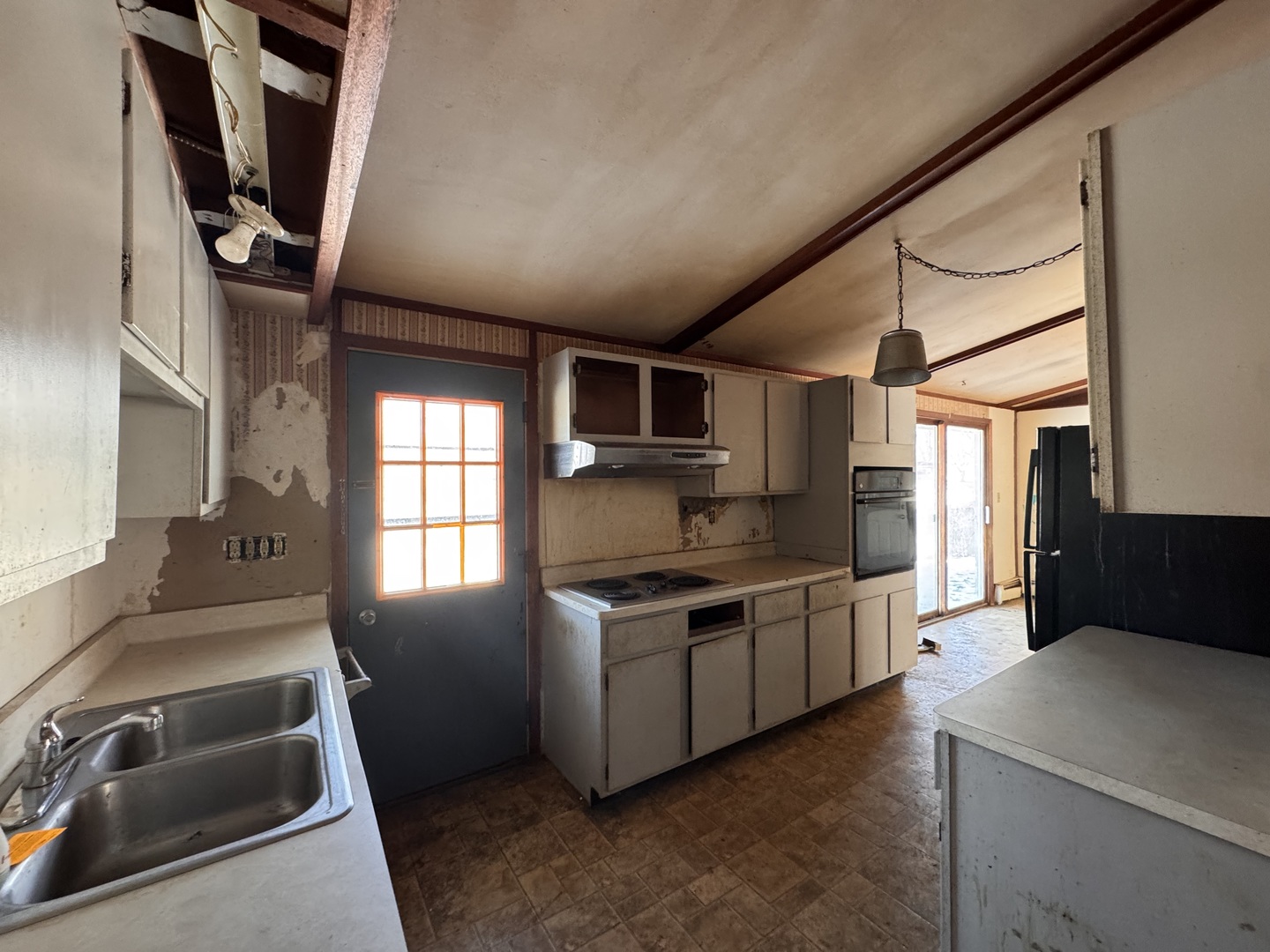 806 Northeast 3rd Street Galva, IL 61434 - Photo 9 of 20 a kitchen with stainless steel appliances granite countertop a sink and a refrigerator