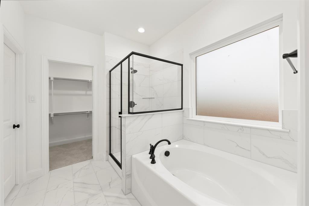 1809 Gleasondale Place Forney, TX 75126 - Photo 11 of 34 a bathroom with a bathtub and a shower