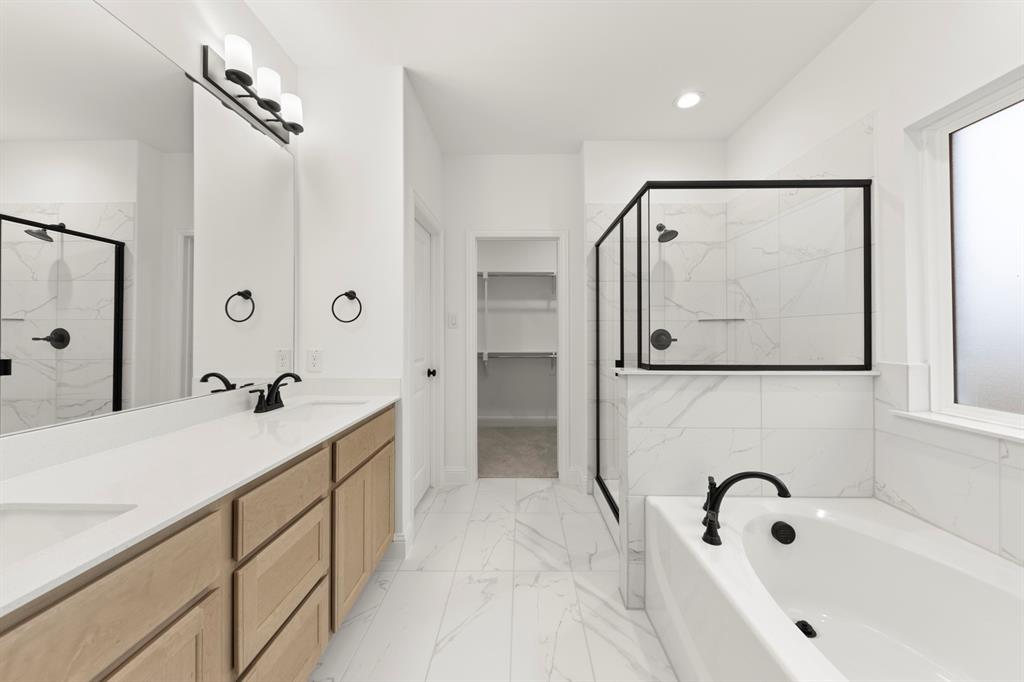 1809 Gleasondale Place Forney, TX 75126 - Photo 12 of 34 a bathroom with a tub sink and mirror