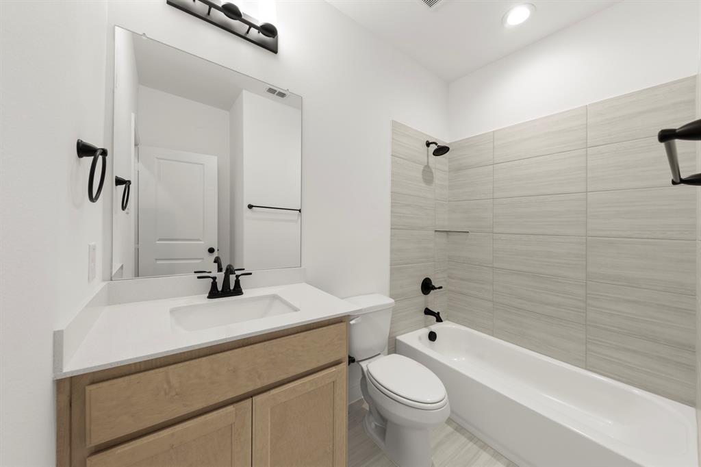 1809 Gleasondale Place Forney, TX 75126 - Photo 19 of 34 a bathroom with a sink a toilet and shower