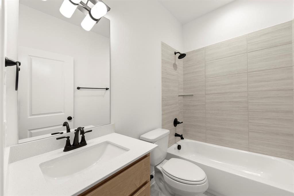 1809 Gleasondale Place Forney, TX 75126 - Photo 21 of 34 a bathroom with a sink a toilet and shower