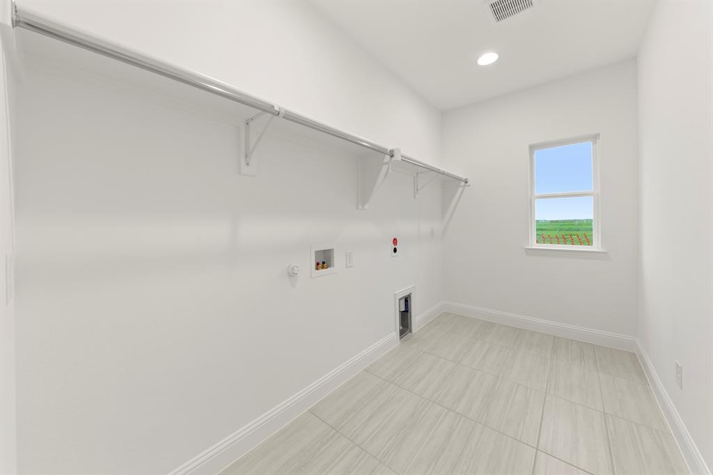 1809 Gleasondale Place Forney, TX 75126 - Photo 23 of 34 an empty room with a white cabinet and a window
