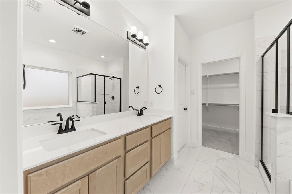 1809 Gleasondale Place Forney, TX 75126 - Photo 10 of 34 a bathroom with a sink and a mirror a vanity