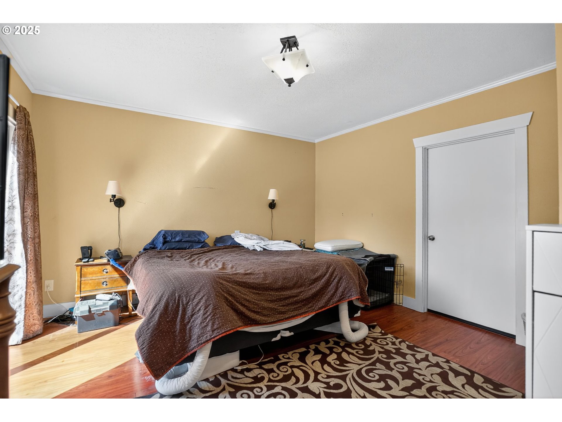 8487 South Sconce Road Canby, OR 97013 - Photo 12 of 27 a bedroom with a bed and wooden floor