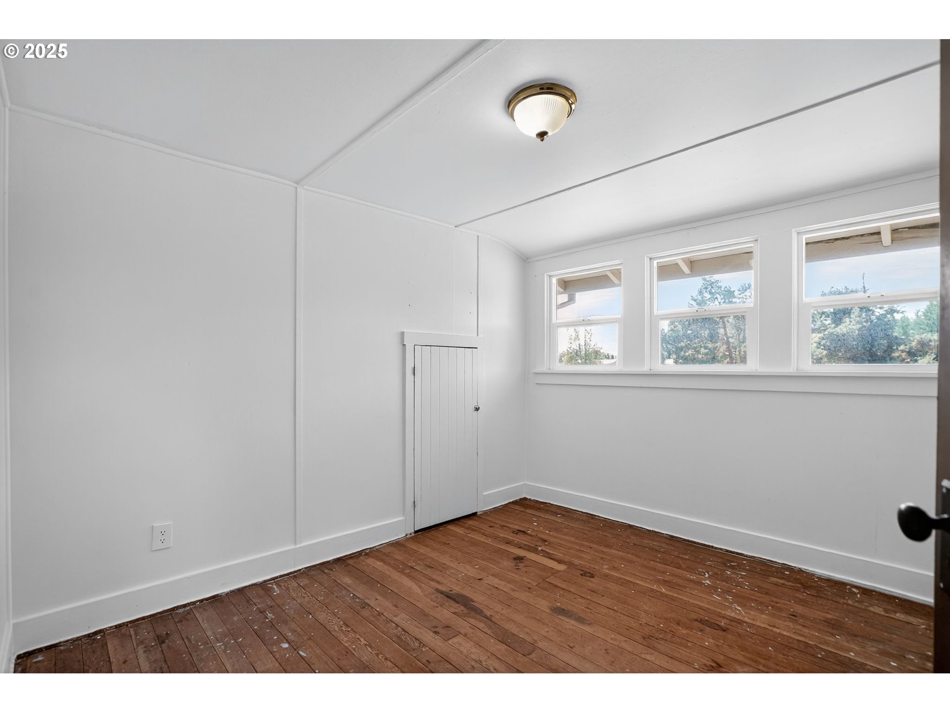 8487 South Sconce Road Canby, OR 97013 - Photo 20 of 27 a view of an empty room with a window and wooden floor