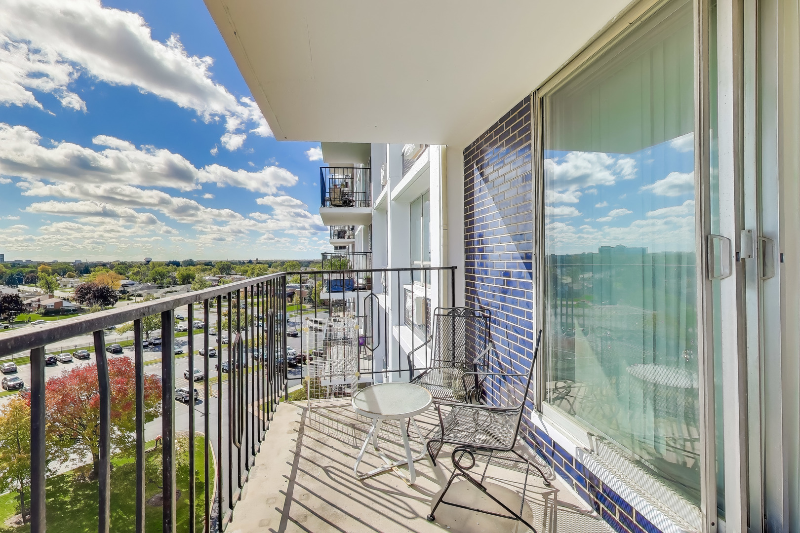 8809 West Golf Road, Unit 8I Niles, IL 60714 - Photo 13 of 27 a view of a balcony with wooden floor and iron stairs