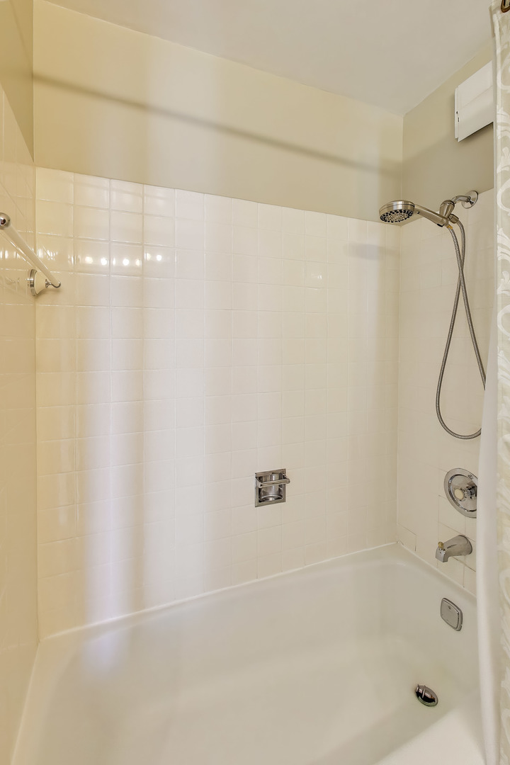 8809 West Golf Road, Unit 8I Niles, IL 60714 - Photo 16 of 27 a bathroom with a shower and a shower