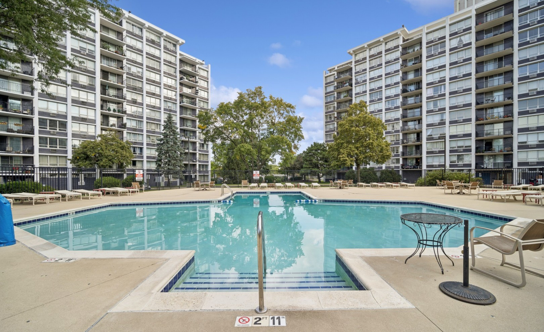 8809 West Golf Road, Unit 8I Niles, IL 60714 - Photo 2 of 27 a view of swimming pool with outdoor seating