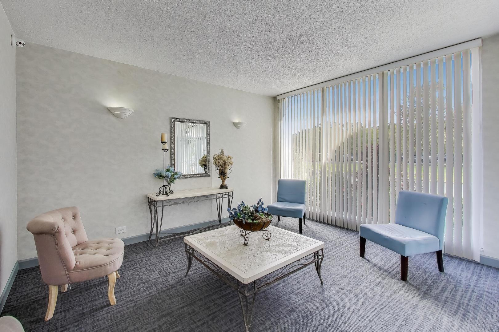 8809 West Golf Road, Unit 8I Niles, IL 60714 - Photo 22 of 27 a living room with furniture and a wooden floor