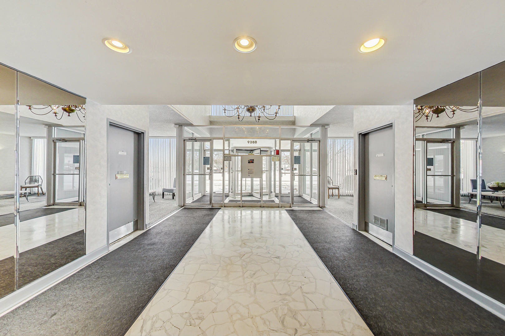 8809 West Golf Road, Unit 8I Niles, IL 60714 - Photo 24 of 27 a view of a big room with windows and chandelier