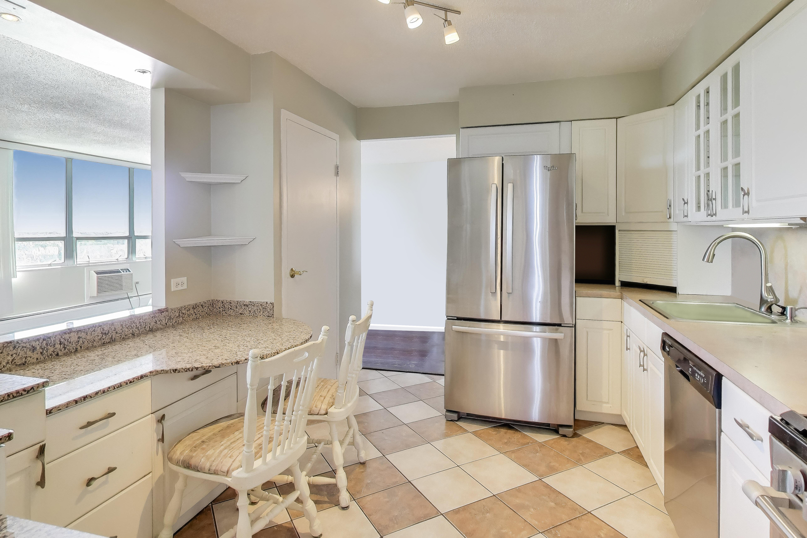 8809 West Golf Road, Unit 8I Niles, IL 60714 - Photo 7 of 27 a kitchen with stainless steel appliances a refrigerator sink and cabinets