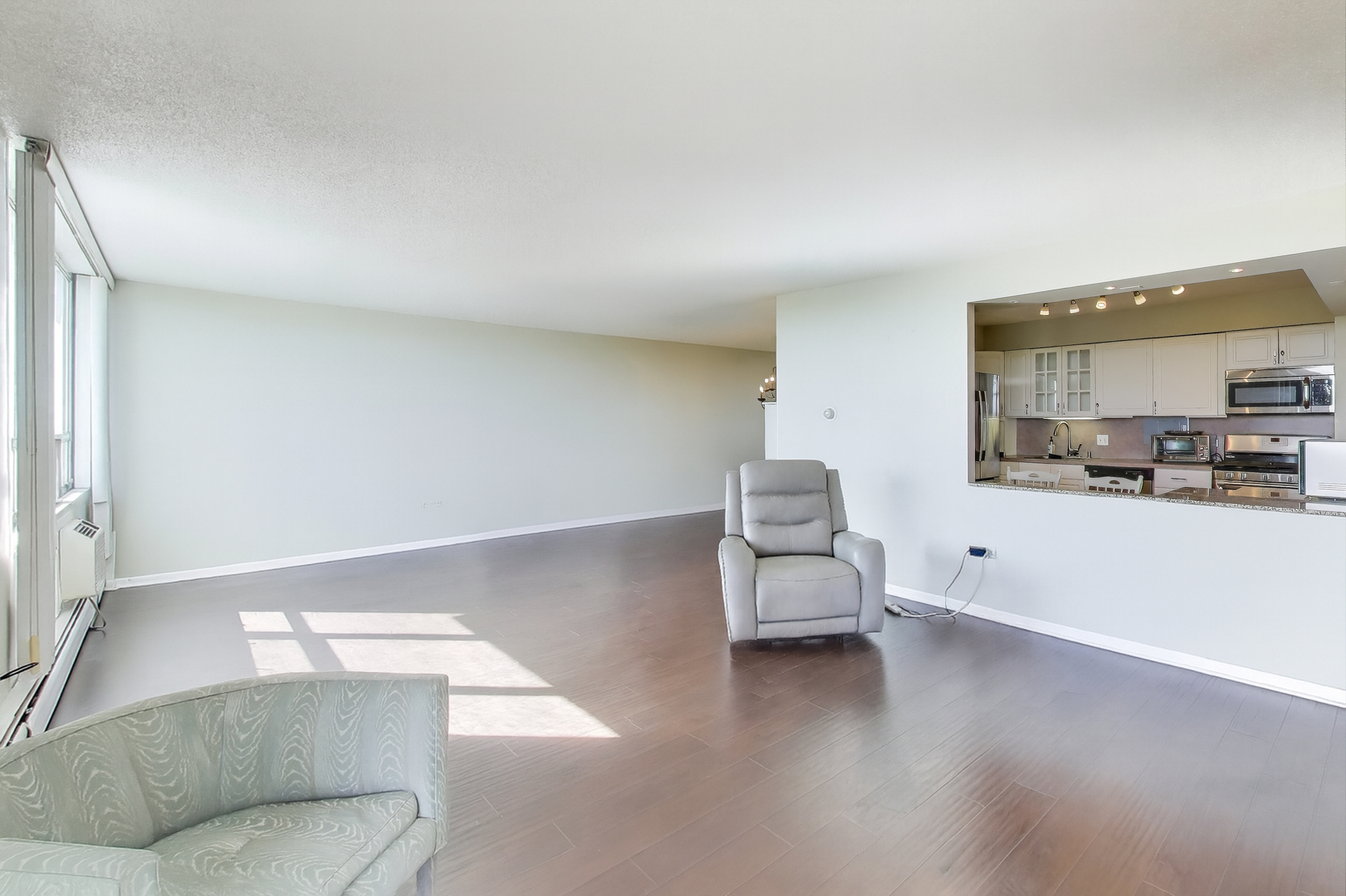 8809 West Golf Road, Unit 8I Niles, IL 60714 - Photo 9 of 27 a living room with furniture and a large window