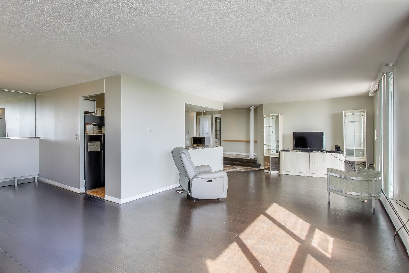 8809 West Golf Road, Unit 8I Niles, IL 60714 - Photo 10 of 27 a living room with furniture and wooden floor