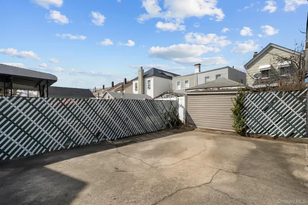 a view of a brick house with wooden fence