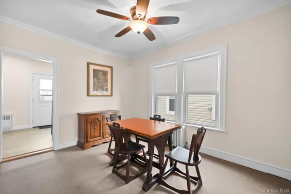 a view of a dining room with furniture and a window