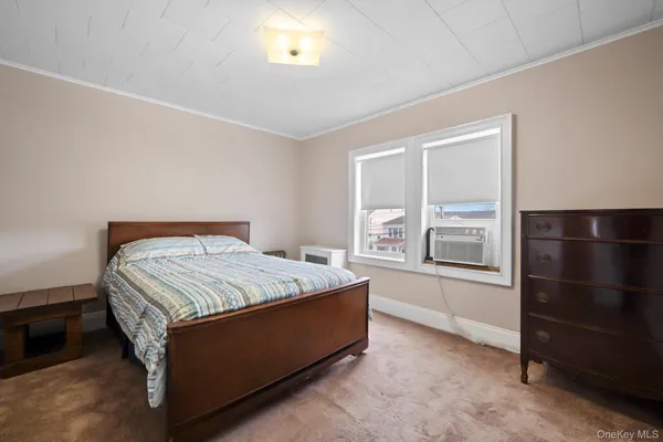 a bed sitting in a room next to a window