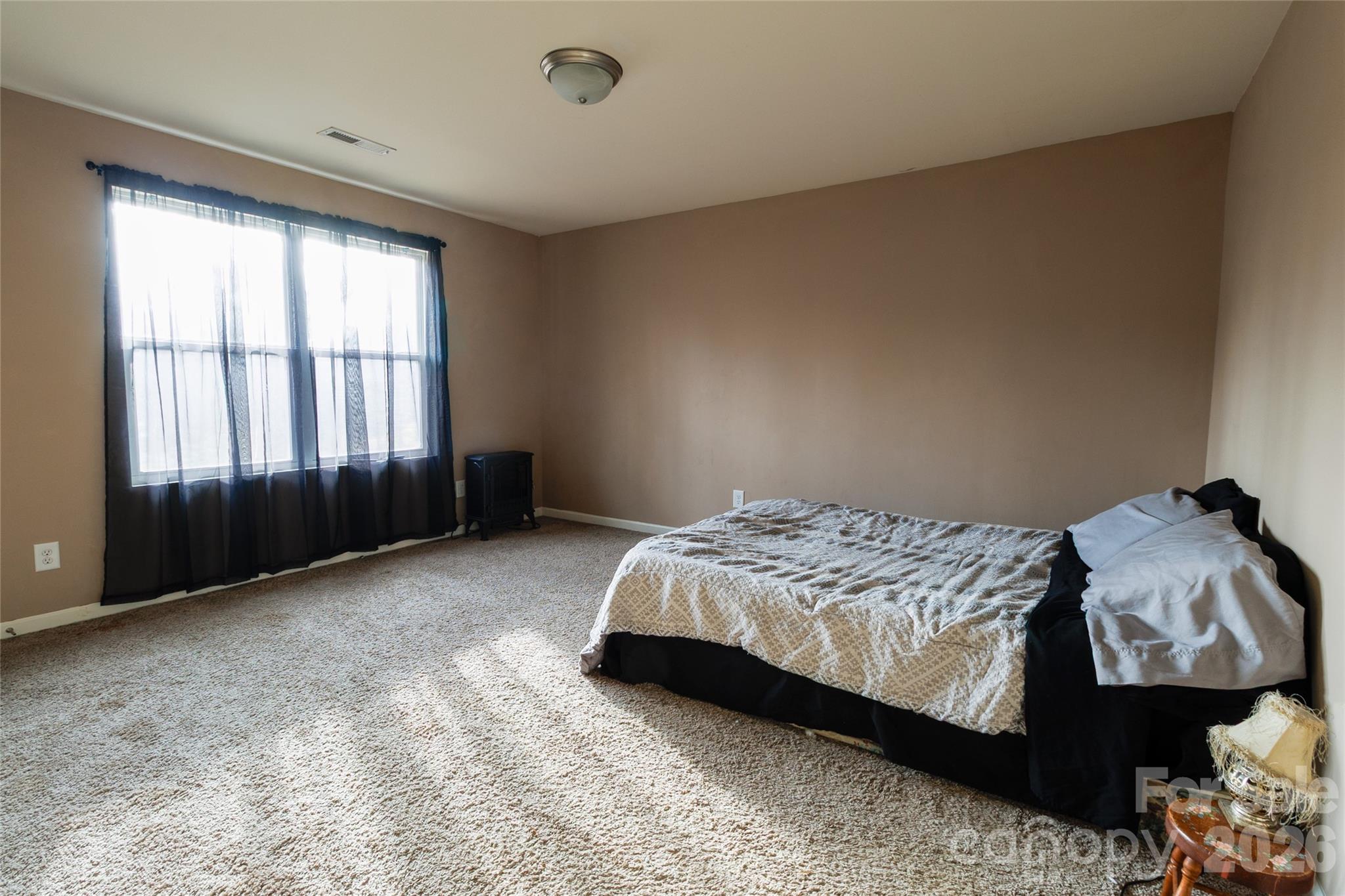 658 Buckskin Road Oakboro, NC 28129 - Photo 13 of 30 a bedroom with a bed and a window