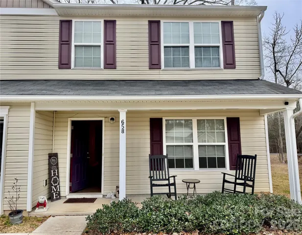 a bedroom with a bed and a flat tv screen on dresser