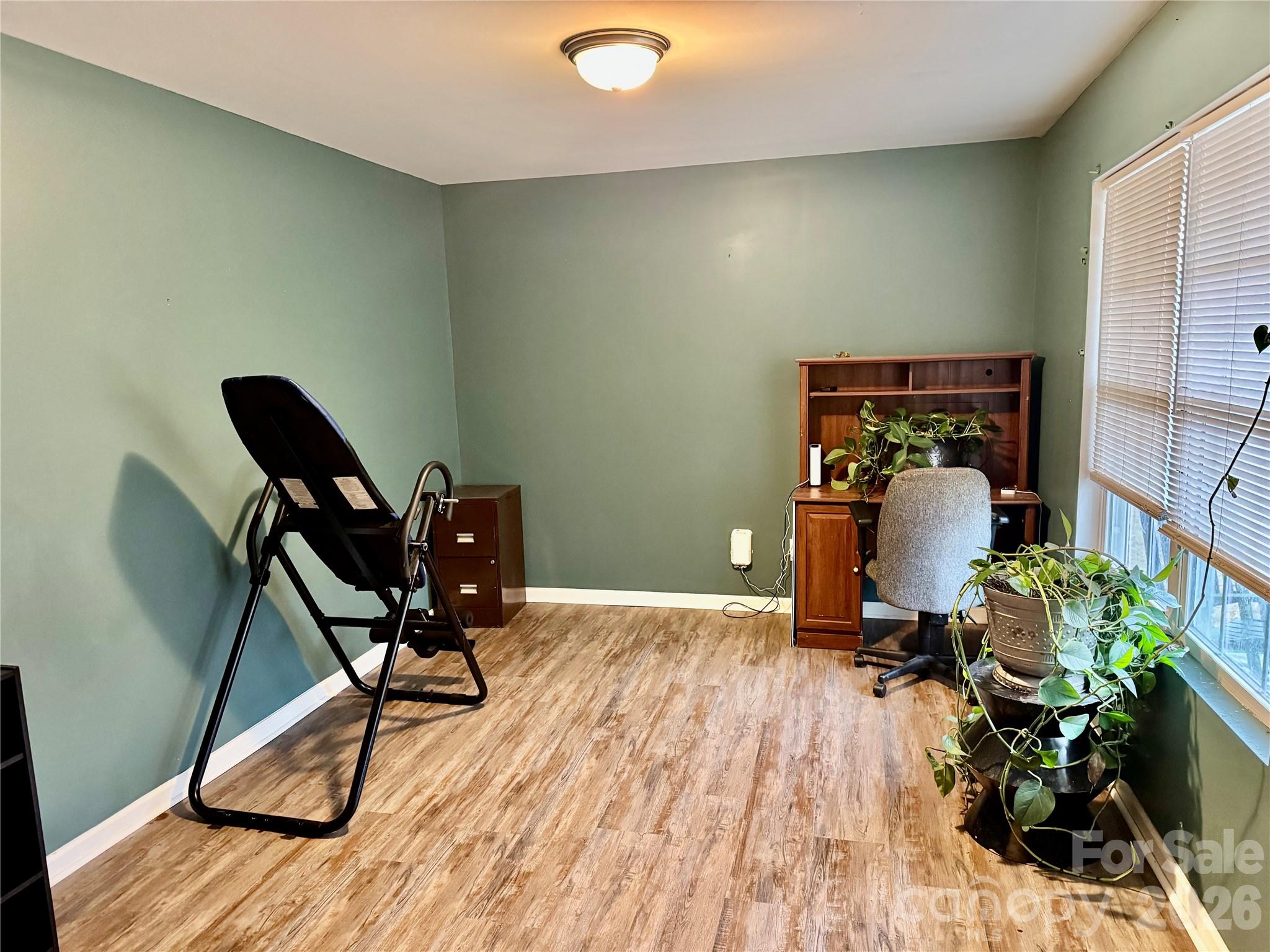 658 Buckskin Road Oakboro, NC 28129 - Photo 17 of 30 a workspace with furniture and wooden floor