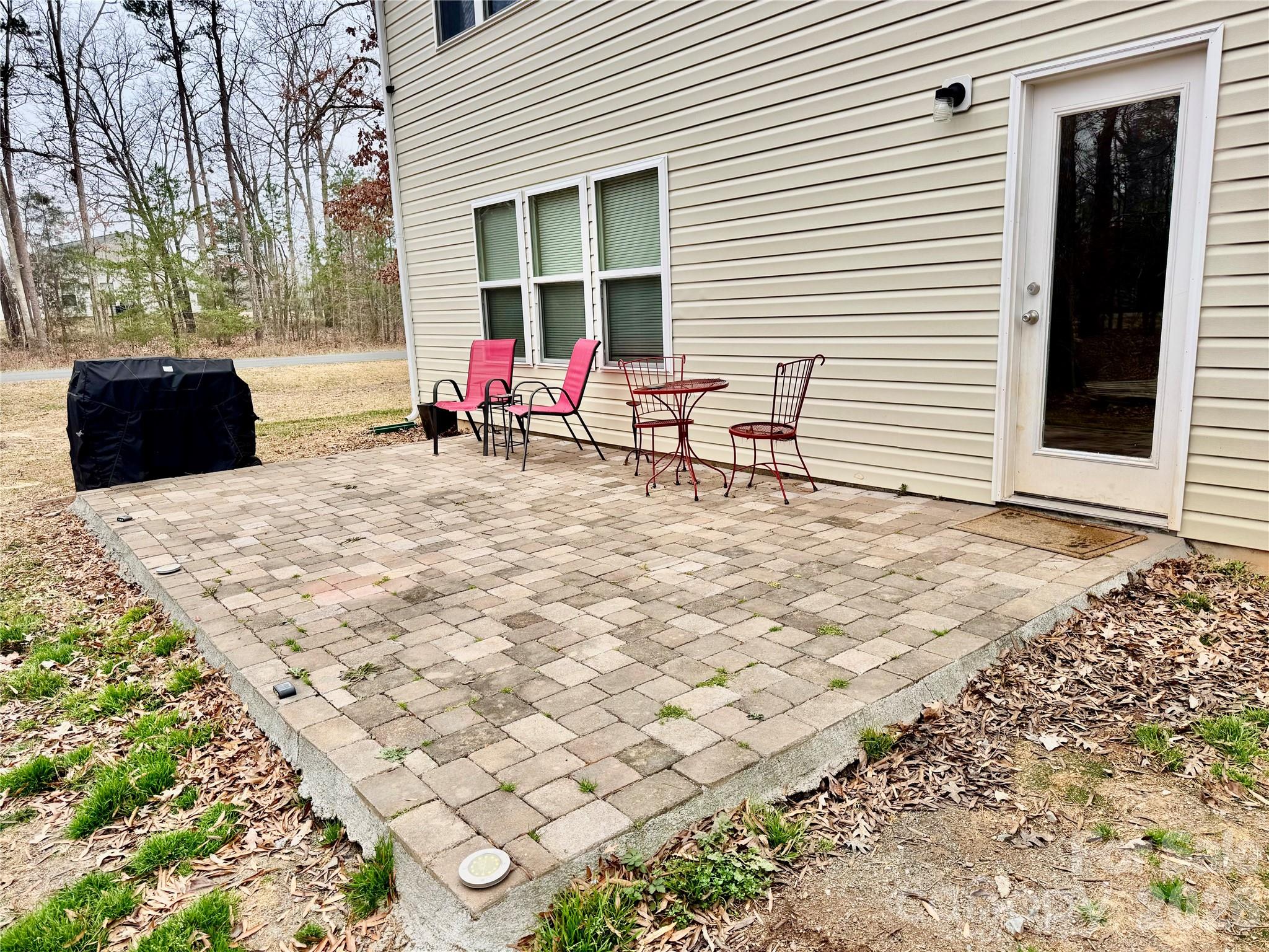 658 Buckskin Road Oakboro, NC 28129 - Photo 23 of 30 a backyard of a house with table and chairs and potted plants