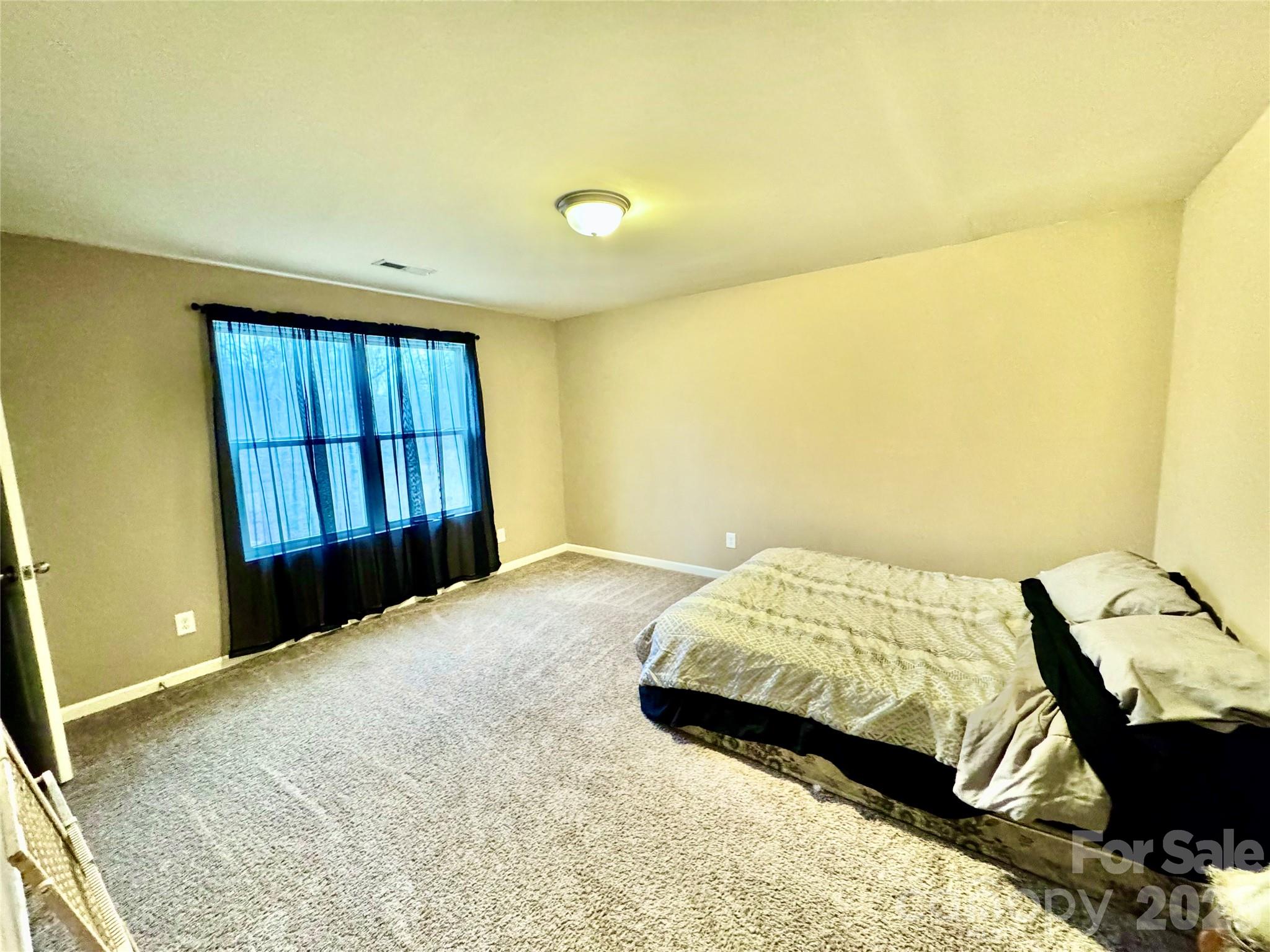 658 Buckskin Road Oakboro, NC 28129 - Photo 30 of 30 a bedroom with a bed and a window