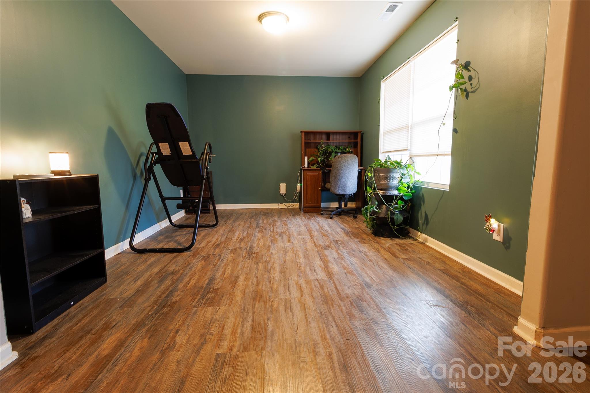 658 Buckskin Road Oakboro, NC 28129 - Photo 8 of 30 a view of a room with gym equipment and wooden floor