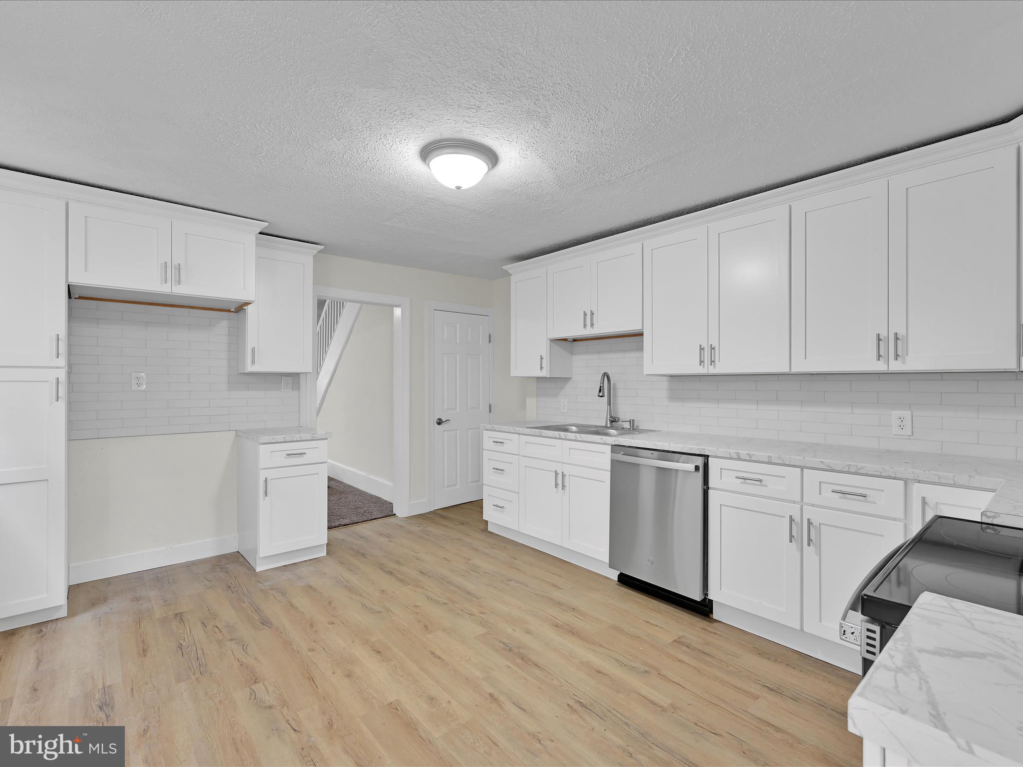 142 West Ruddle Street Coaldale, PA 18218 - Photo 9 of 28 a kitchen with granite countertop white cabinets and white appliances