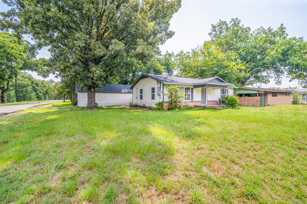 109 Church Street Quinlan, TX 75474 - Photo 2 of 25 a front view of a house with yard and green space