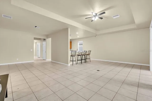 a spacious bedroom with a bed and a window