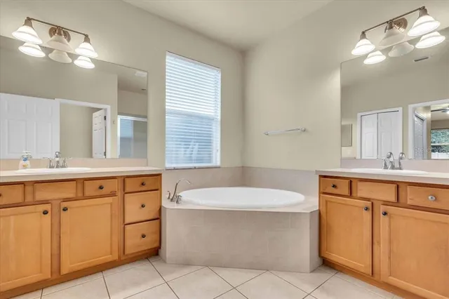 a spacious bathroom with a bathtub sink and mirror