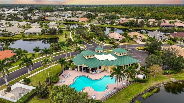an aerial view of a house with a swimming pool yard and outdoor seating