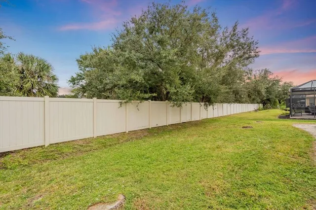 an aerial view of multiple houses with a yard