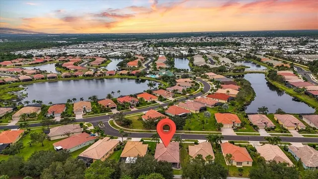 an aerial view of residential houses with outdoor space and trees