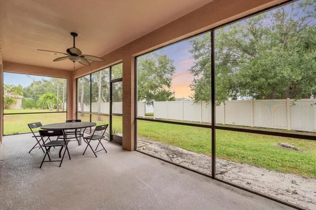 a dining room with furniture and garden view