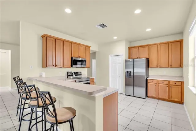 a kitchen with stainless steel appliances a refrigerator sink and cabinets