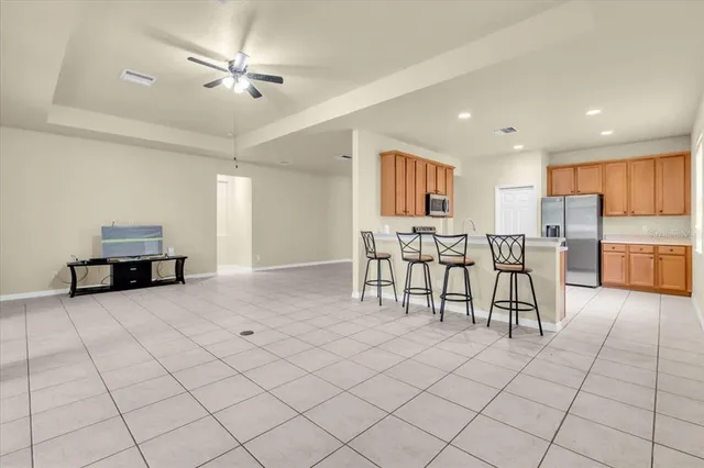 a view of kitchen with furniture and refrigerator