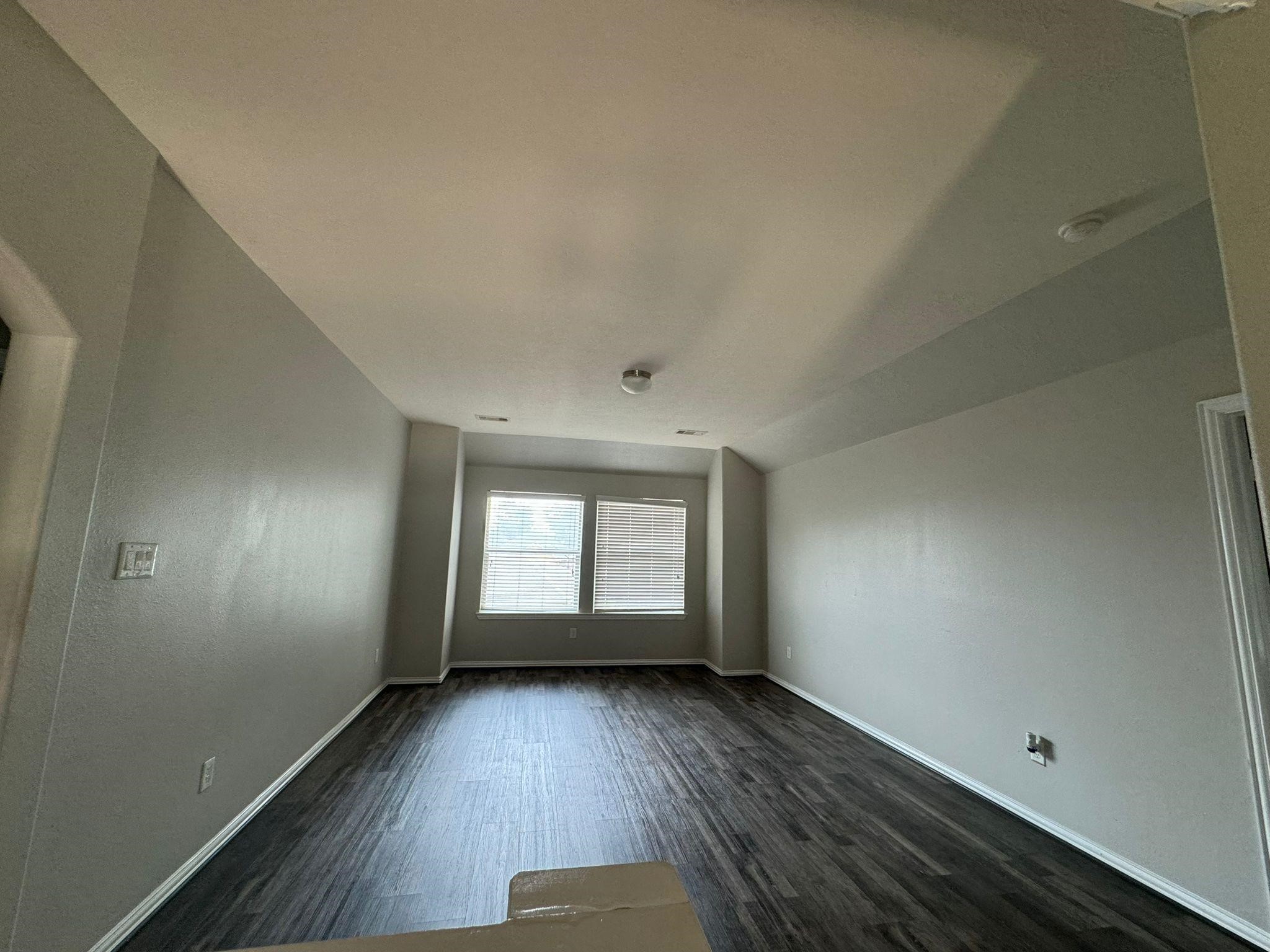 25614 Crisp Spring Lane Spring, TX 77373 - Photo 12 of 25 an empty room with wooden floor and windows