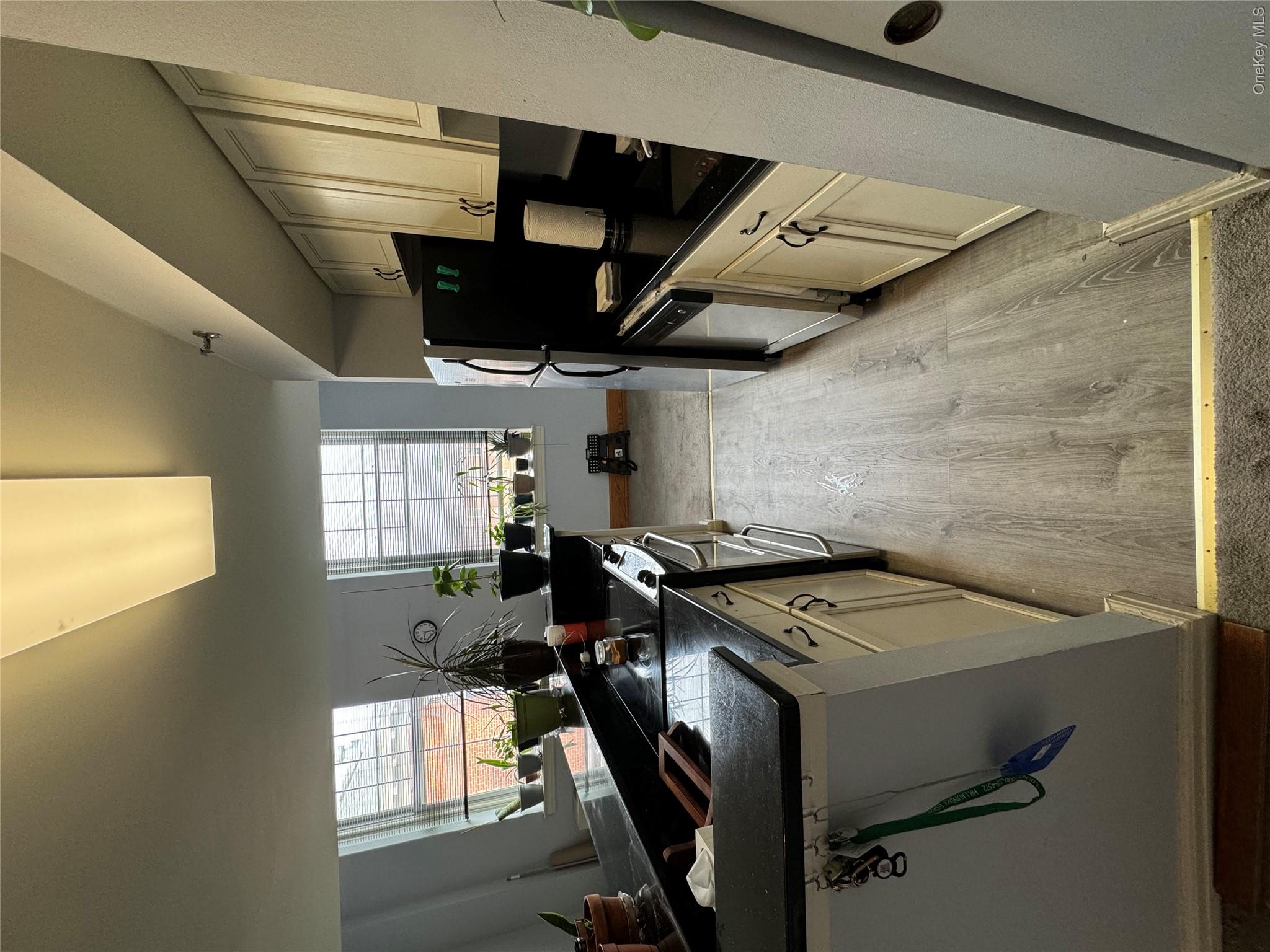 1701 Crompond Road, Unit 6313 Peekskill, NY 10566 - Photo 2 of 13 a kitchen with a sink appliances wooden floor and a window