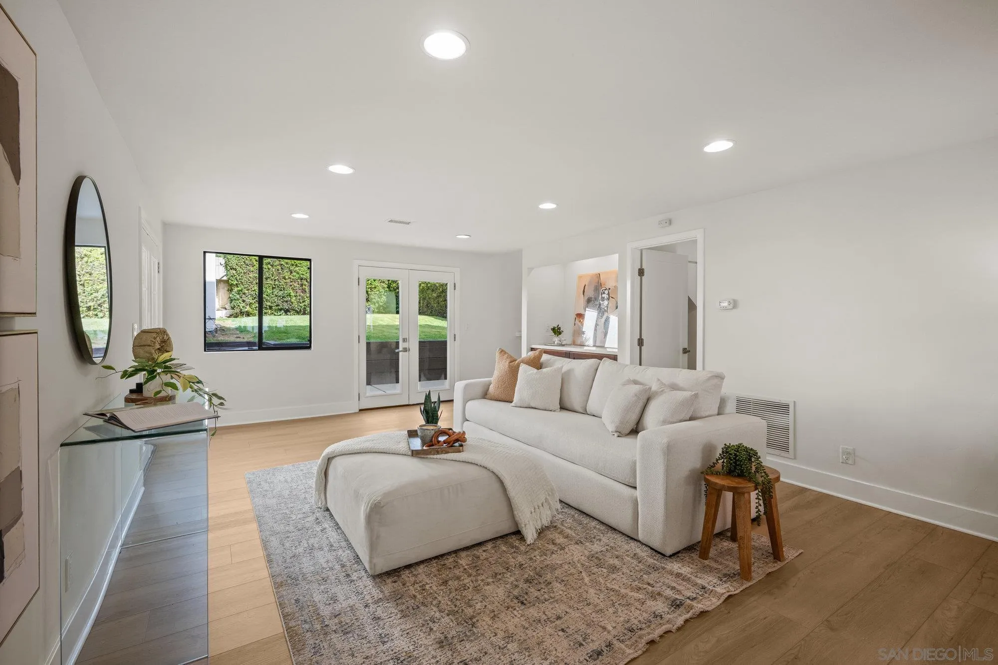 1712 Beryl Street San Diego, CA 92109 - Photo 18 of 37 a living room with furniture and a large mirror