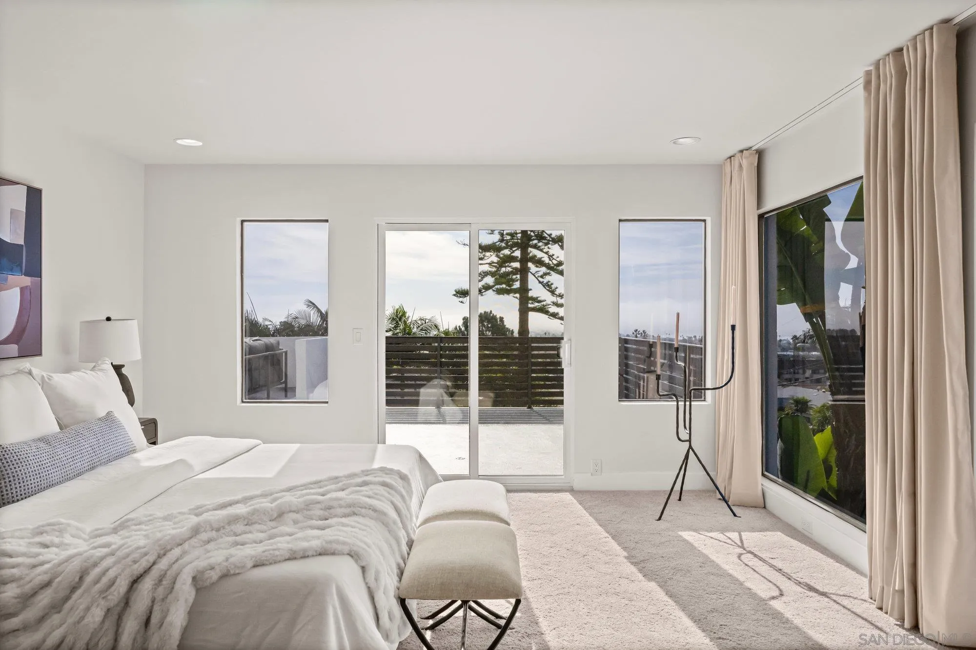 1712 Beryl Street San Diego, CA 92109 - Photo 21 of 37 a bedroom with a large bed and a large window