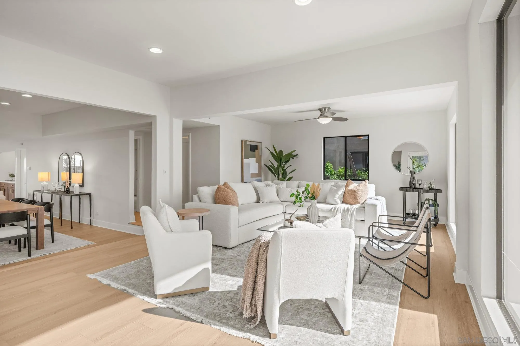 1712 Beryl Street San Diego, CA 92109 - Photo 5 of 37 a living room with patio furniture and a dining table with kitchen view