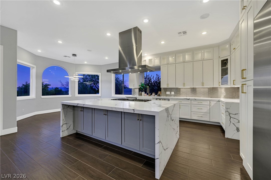 6 Rue Du Ville Henderson, NV 89011 - Photo 34 of 99 This expansive kitchen features a waterfall island, sleek appliances, and ample cabinetry for culinary pursuits.